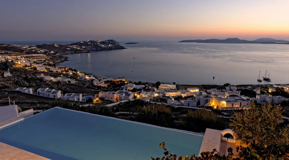 For Sale: Luxurious Villa with Stunning Aegean Views in Mykonos, Agios Ioannis Diakoftis Embodying the essence of "Location, Location, Location," this exquisite villa in Agios Ioannis Diakoftis, Mykonos, is the epitome of luxury and serenity. Set on a spacious 4,530 sq.m. plot with panoramic views of Delos and the Cyclades, this property offers breathtaking sunset vistas, an expansive infinity pool, and high-end amenities. Built in 2000, the villa seamlessly combines timeless elegance with modern conveniences, creating a tranquil retreat amid the allure of Mykonos. Property Details Location: Agios Ioannis Diakoftis, Mykonos Villa Size: 235 sq.m. Plot Size: 4,530 sq.m. Bedrooms: 4 Bathrooms: 4 Parking: Capacity for 5 cars Construction Year: 2000, with modern renovations Key Features This single-level villa welcomes you with an ambiance of warmth and luxury. Inside, the inviting living space is complemented by a cozy fireplace and underfloor heating, ideal for year-round comfort. High-quality finishes, thoughtful design, and spacious bedrooms ensure a sophisticated yet relaxing atmosphere. Interior Layout The villa comprises four elegantly designed bedrooms, each offering privacy and style. The two main suites, accessible via separate entrances, include a master suite with a double bed and a twin suite, both with en-suite bathrooms. The open-plan layout enhances the sense of spaciousness, and every room is designed to capture the striking views of the Aegean. Outdoor Space The landscaped grounds of this villa include lush gardens and an ancient olive tree, all framed by the endless horizon. The highlight is the large infinity pool, offering a seamless transition from the property to the blue sea. Comfortable sun loungers and outdoor seating provide ideal spaces for relaxation, while the vast plot allows for potential outdoor activities and social gatherings. Investment Potential The villa's prime location in Agios Ioannis and proximity to Mykonos town make it a highly attractive property, suitable as a primary residence or as a high-end vacation rental. The views of Delos and the surrounding Cyclades islands add unique appeal, making this villa a standout investment for those seeking a luxurious, secluded home in Greece's iconic island destination. For more information or to schedule a private viewing of this breathtaking villa, please reach out. This is an opportunity to own a piece of paradise in Mykonos, where the sky and sea become one.